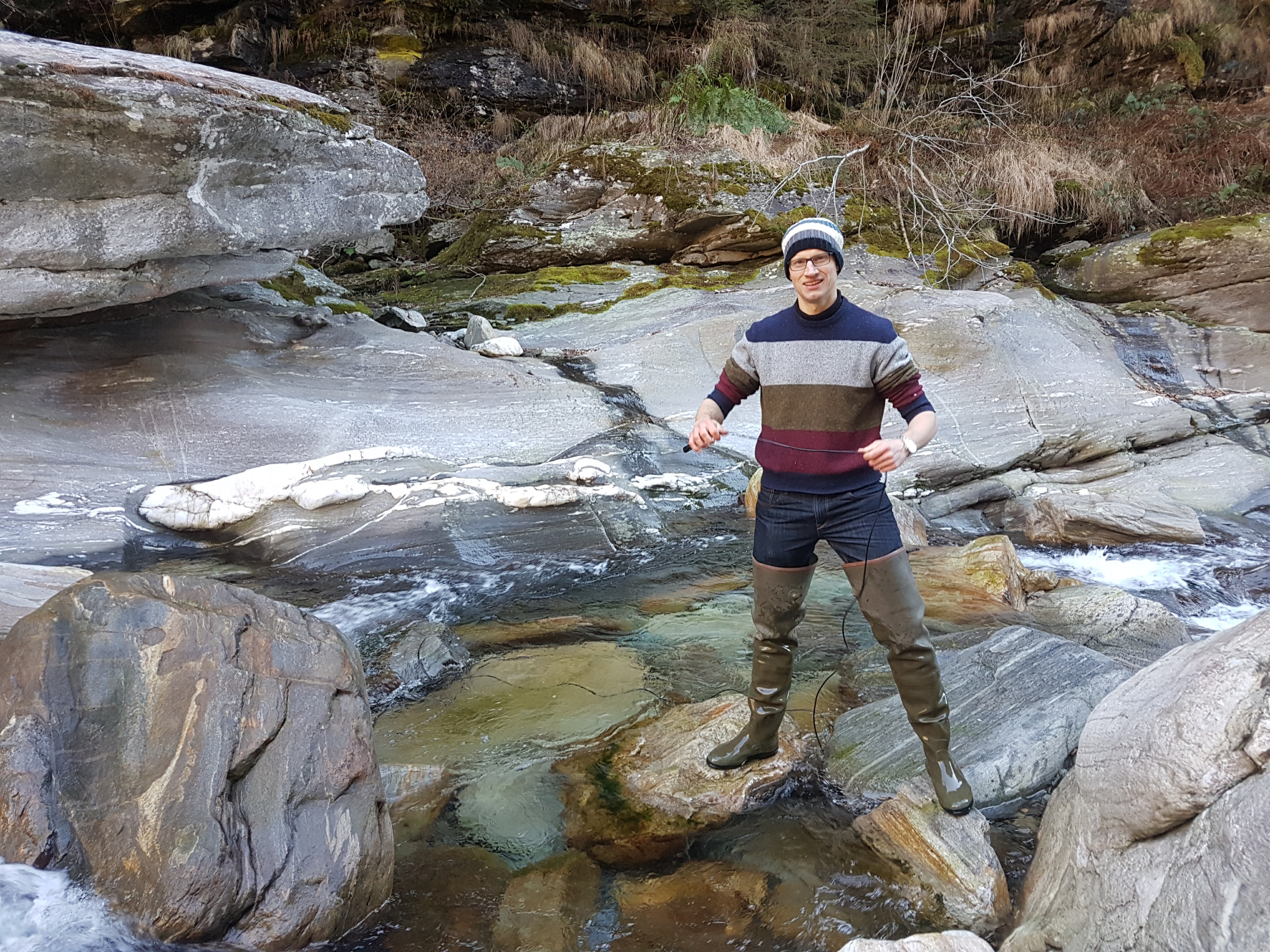 Pierre-Jacques Frank, specialist engineer in Environment/Water Management, performing a discharge measurement using a salt refraction method on the Calancasca River in his fishing boots.