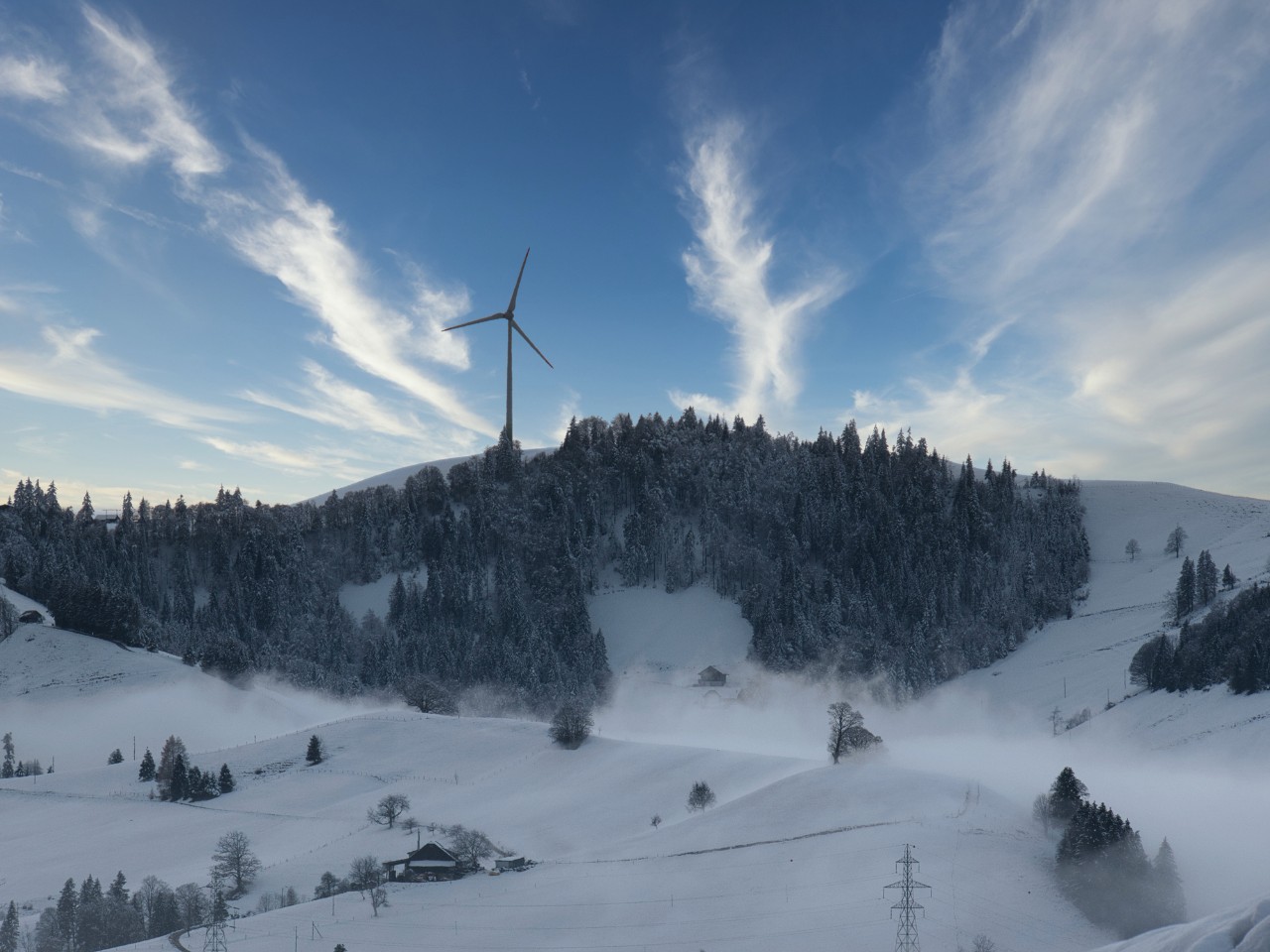 Wind turbine on a snow-covered hill